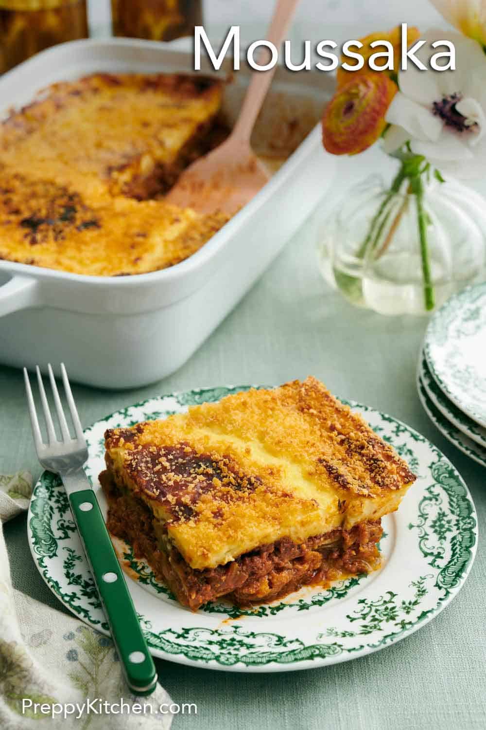 Greek chef preparing moussaka in a kitchen