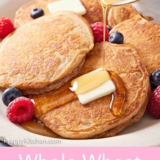 Pinterest graphic of syrup poured over a plate of whole wheat pancakes, berries, and butter.