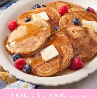 Pinterest graphic of a platter of whole wheat pancakes, berries, and butter with syrup.