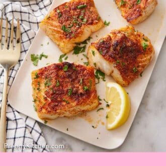 Pinterest graphic of a platter with four pieces of air fryer cod and lemon wedges, garnished with chopped parsley.