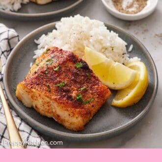 Pinterest graphic of a plate with an air fryer cod, lemon wedges, and rice. A second plated portion in the back.