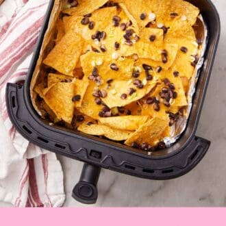 Pinterest graphic of an air fryer basket lined with foil with air fryer nachos topped with green onions and black beans.