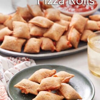 Pinterest graphic of a plate of air fryer pizza rolls with a platter in the background containing more along with a bowl of marinara sauce.