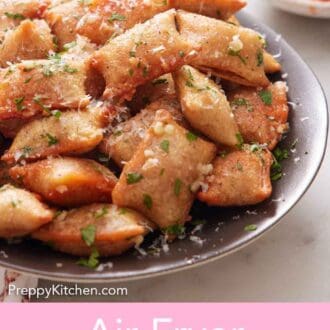 Pinterest graphic of a close up view of air fryer pizza rolls with chopped parsley and parmesan on top.