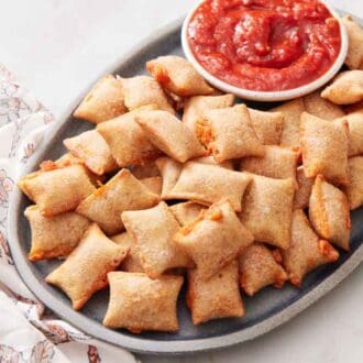 A platter of air fryer pizza rolls with marinara sauce.