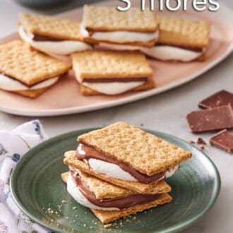 Pinterest graphic of a plate with two air fryer s'mores stacked. More air fryer s'mores in the background on a platter.