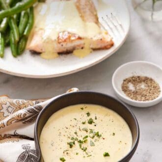 Pinterest graphic of a bowl of béarnaise sauce with chopped tarragon leaves as garnish. A bowl of pepper in the background along with a plate of salmon and green beans with béarnaise sauce.