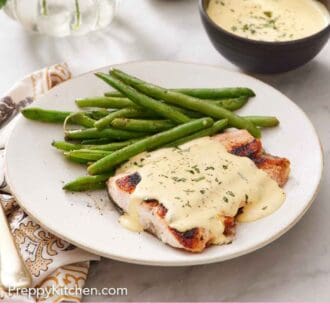 Pinterest graphic of a plate of salmon with béarnaise sauce on top along with green beans.