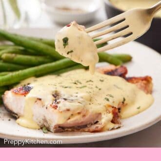 Pinterest graphic of a fork lifting up a bite of salmon coated with béarnaise sauce from a plate with salmon and green beans.