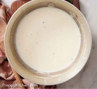 Pinterest graphic of an overhead view of a pot of béchamel sauce.