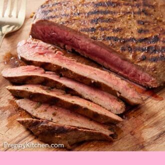 Pinterest graphic of carne asada on a wooden cutting board, partially sliced.