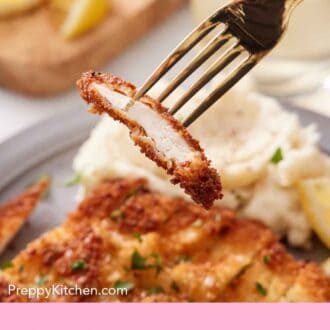 Pinterest graphic of piece of sliced chicken schnitzel lifted with a fork from a plated serving.