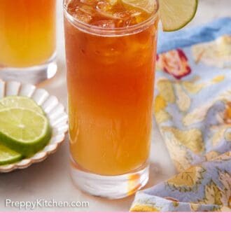 Pinterest graphic of a glass of Dark and Stormy with a lime wheel placed onto the rim.