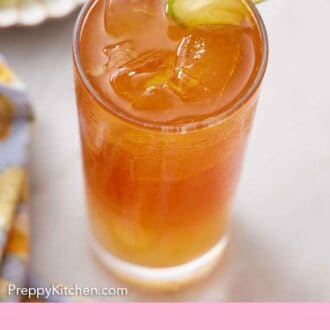 Pinterest graphic of a glass of Dark and Stormy with a lime wheel on the rim.