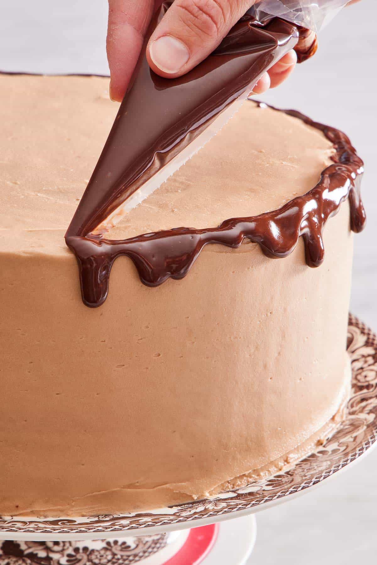 Chocolate ganache piped over the edge of the cake.