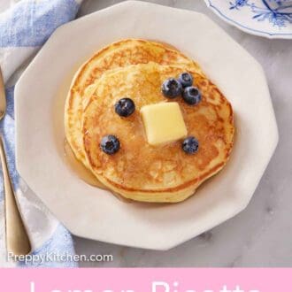 Pinterest graphic of maple syrup and blueberries on top of two lemon ricotta pancakes on a white plate. A cup of coffee on the side.