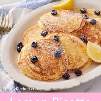 Pinterest graphic of a platter of lemon ricotta pancakes with fresh blueberries and lemon wedges. A dusting of powdered sugar on top.