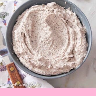 Pinterest graphic of a bowl of Oreo frosting. Some piping tips and broken Oreo cookies off to the side.