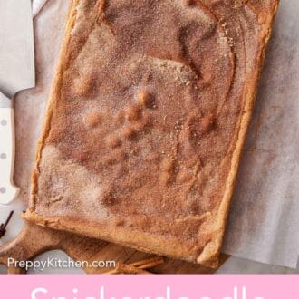 Pinterest graphic of a slab of snickerdoodle bars before slicing on a wooden serving board topped with cinnamon sugar.