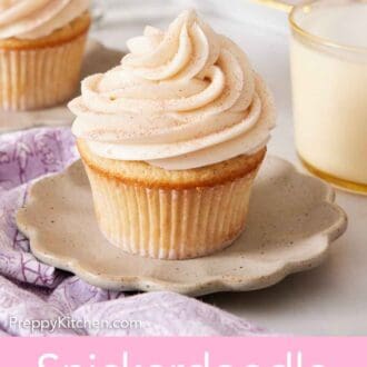 Pinterest graphic of a plate with a snickerdoodle cupcake on top. A glass of milk in the background along with more cupcakes.