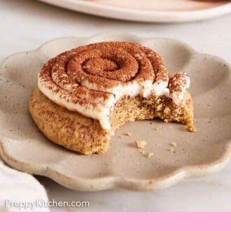 Pinterest graphic of a plate with a tiramisu cookie with a bite taken out.