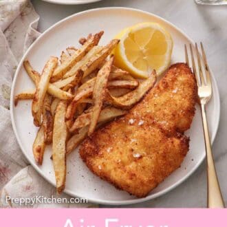 Pinterest graphic of a plated serving of air fryer fish and chips with lemon wedges and a fork.