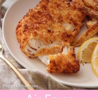 Pinterest graphic of a piece of air fryer fish flaked opened with some fries and lemon wedges on the side.