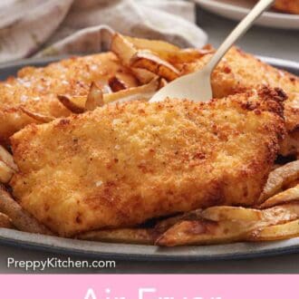 Pinterest graphic of a platter of air fryer fish and chips with a fork lifting up a piece of fish.