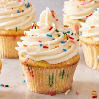 Multiple funfetti cupcakes topped with frosting and rainbow sprinkles.