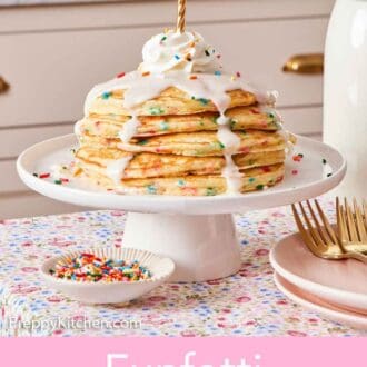 Pinterest graphic of a small cake stand with a stack of funfetti pancakes with icing, whipped cream, and a lit candle on top.