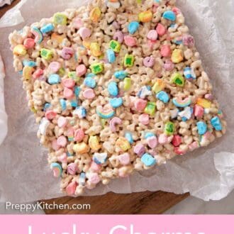 Pinterest graphic of an overhead view of a slab of uncut Lucky Charms treats on a parchment-lined serving board.