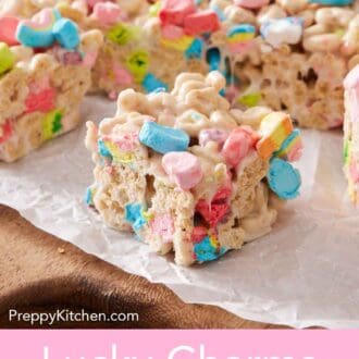 Pinterest graphic of a Lucky Charms treat cut from the rest of the slab on a parchment-lined serving board.