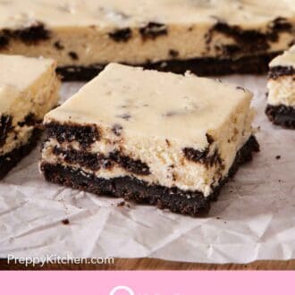 Pinterest graphic of a cut Oreo cheesecake bars on a parchment-lined wooden serving board.