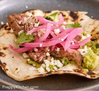 Pinterest graphic of pickled onions on top of a steak taco on a plate.