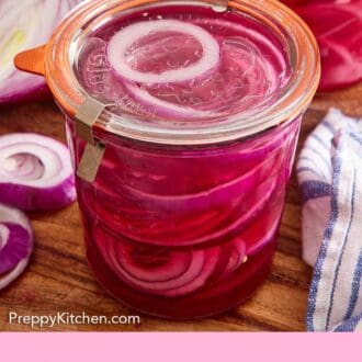 Pinterest graphic of a jar of pickled onions on a wooden board with more red onions scattered around.