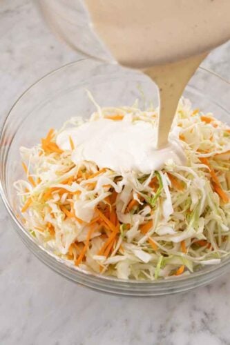 Creamy dressing poured over shredded veggies.