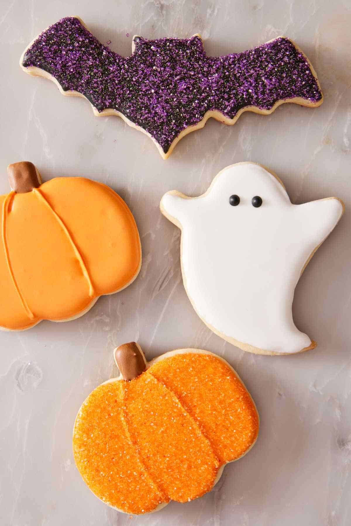 Sugar cookies cut into Halloween shapes and decorated with icing accordingly.
