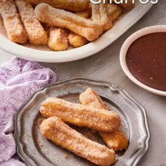 Pinterest graphic showing 3 air fryer churros on a plate with more on a platter in the background.