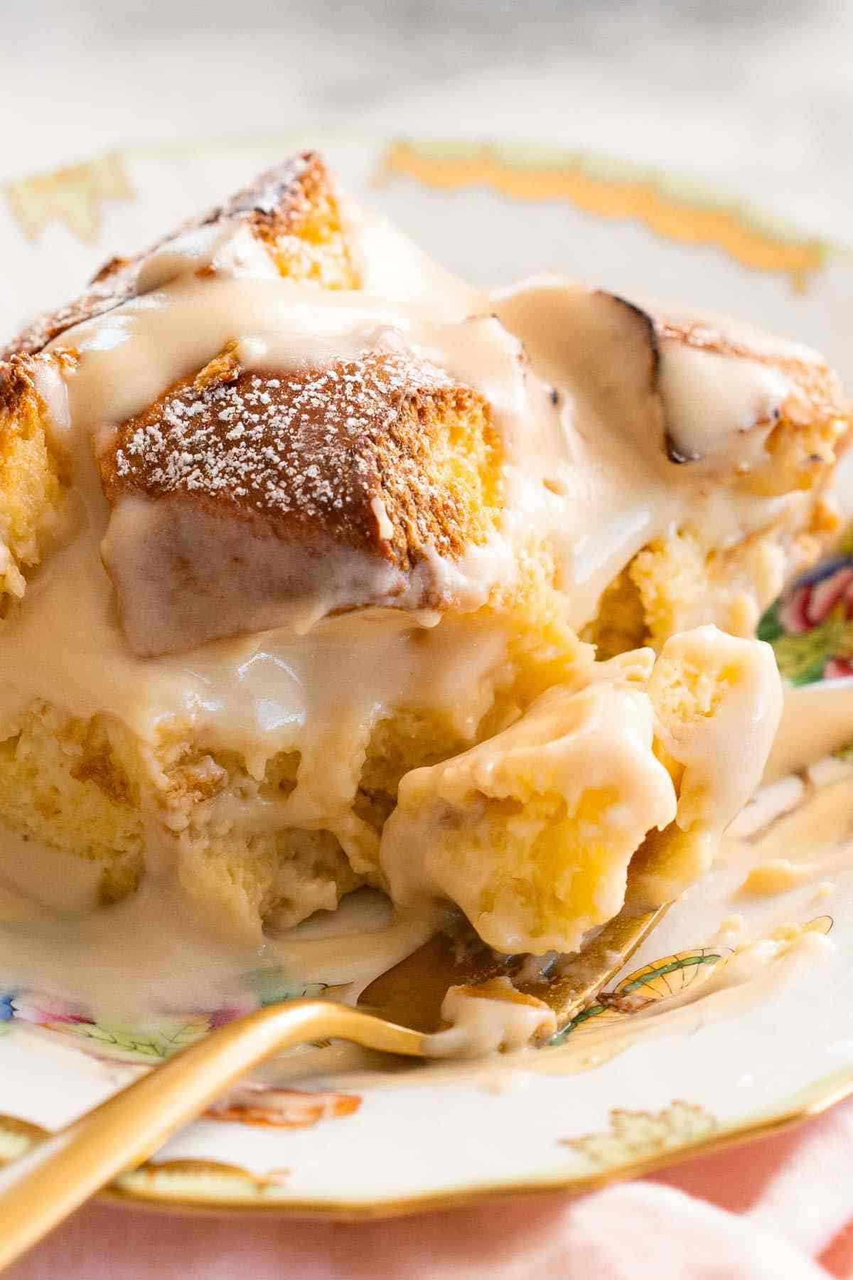 Close-up of easy bread pudding on a plate with a fork.