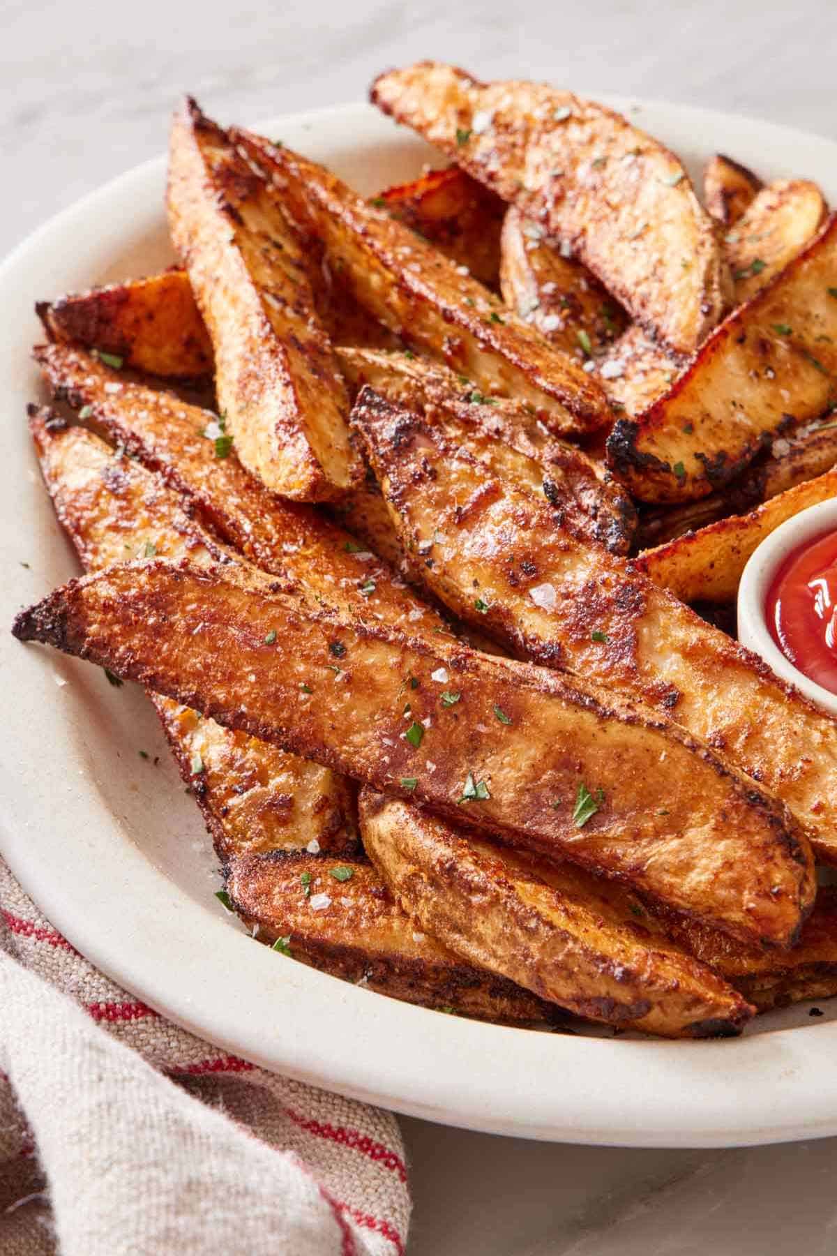 Crisp baked potato wedges on a plate.