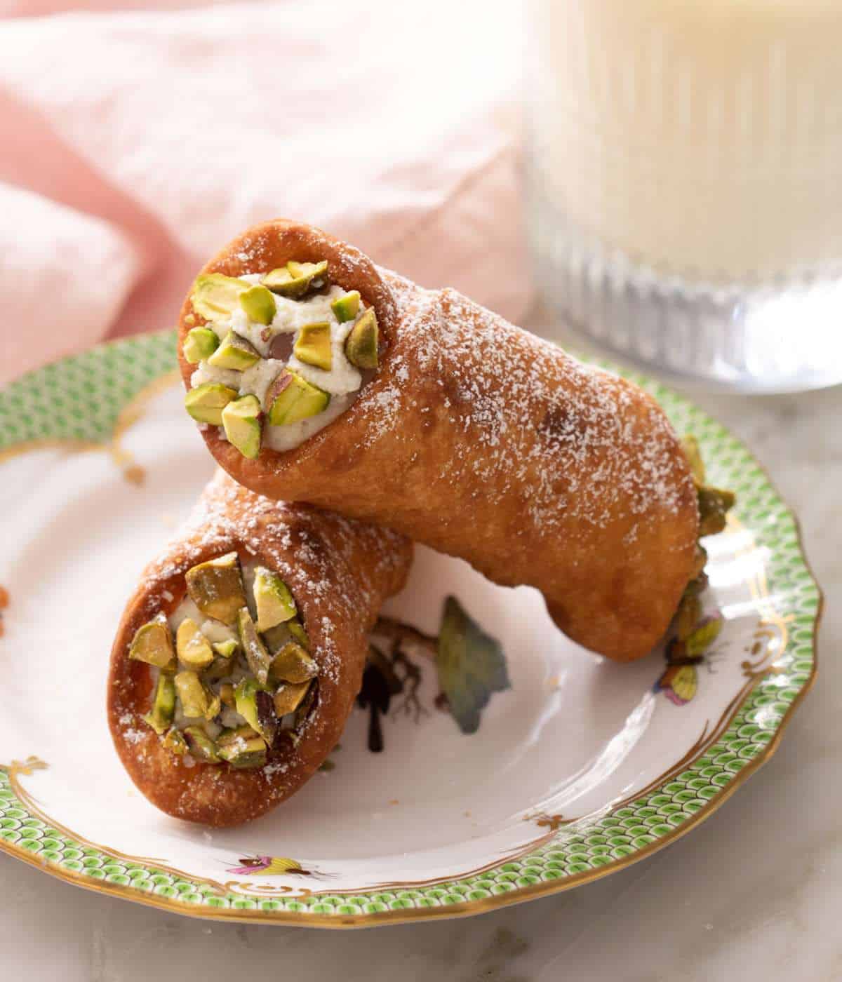Homemade cannoli garnished with chopped pistachios.
