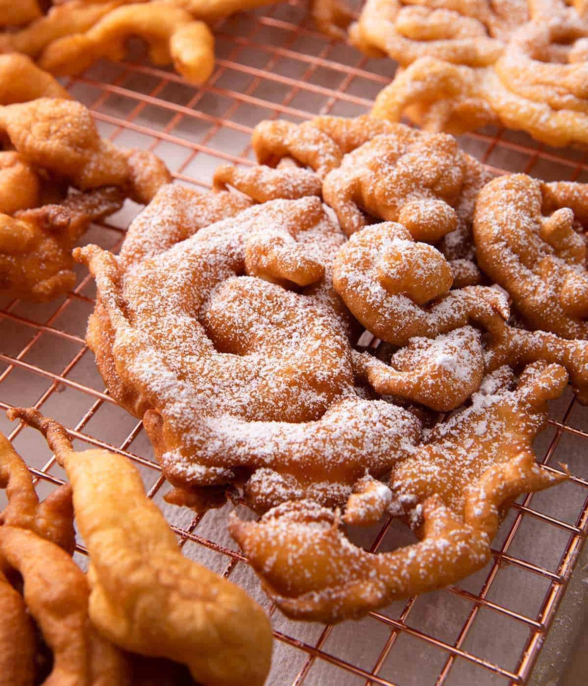Close-up of a funnel cake dusted with powdered sugar.