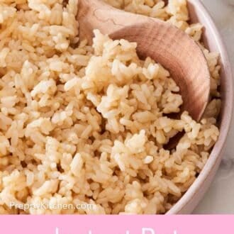 Pinterest graphic of a close-up of Instant Pot brown rice with a wooden spoon scooped in.
