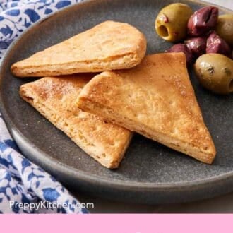 Pinterest graphic showing three pita chips on a small plate with olives.