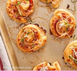 Pinterest graphic showing an overhead shot of homemade pepperoni pizza rolls on a baking sheet.