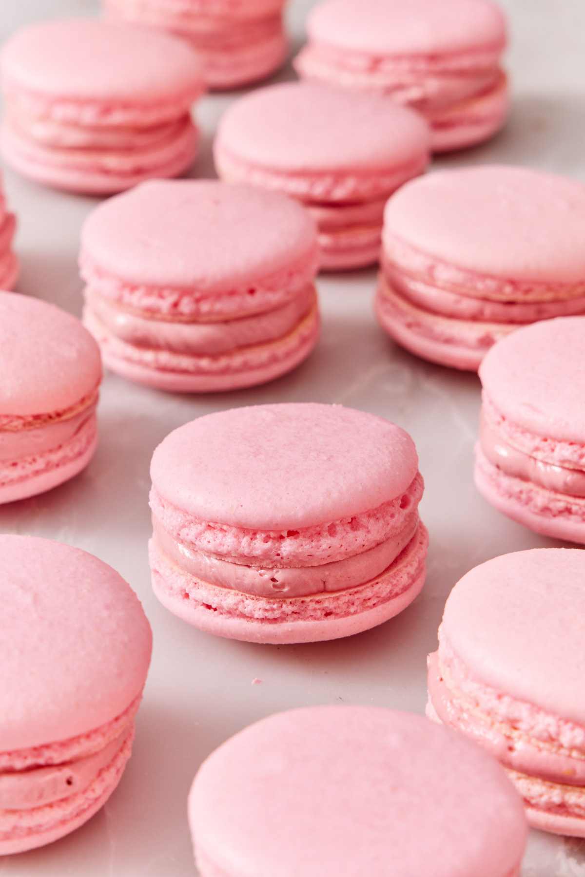 Macarons on a white marble countertop.