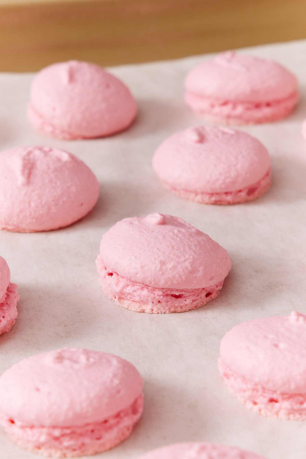 Baked macaron shells made with undermixed batter.