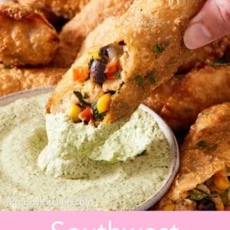 Pinterest graphic showing a southwest egg roll dipped into a sauce with more egg rolls on a platter surrounding it.