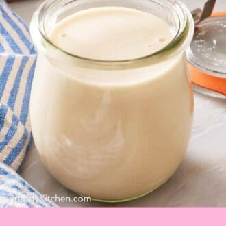 Pinterest graphic showing a glass jar of tahini sauce.