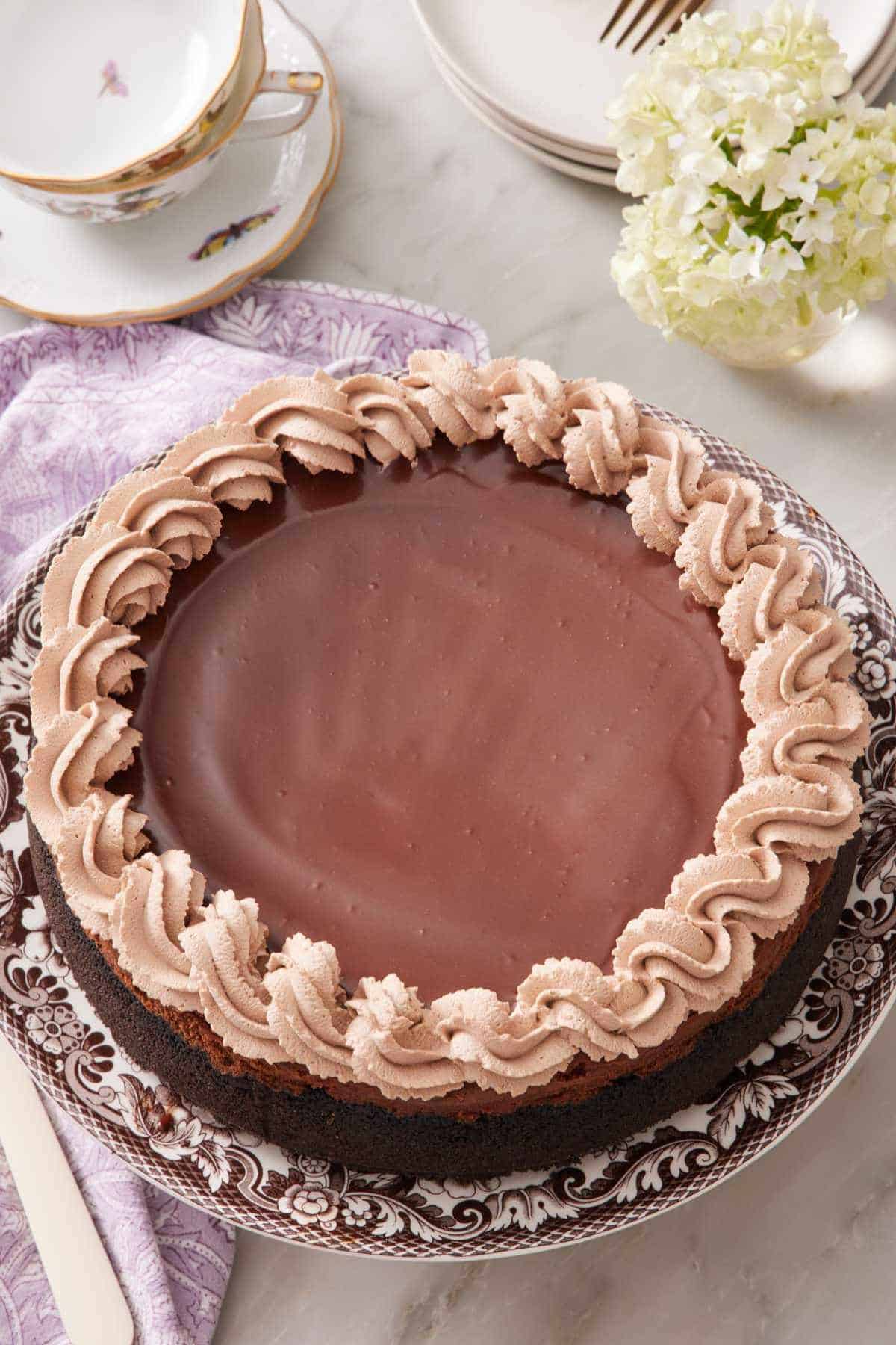 A chocolate cheesecake on a patterned plate.